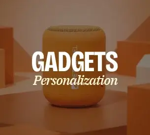 A selection of tech gifts including a Bluetooth speaker, earbuds and a power bank with logo branding